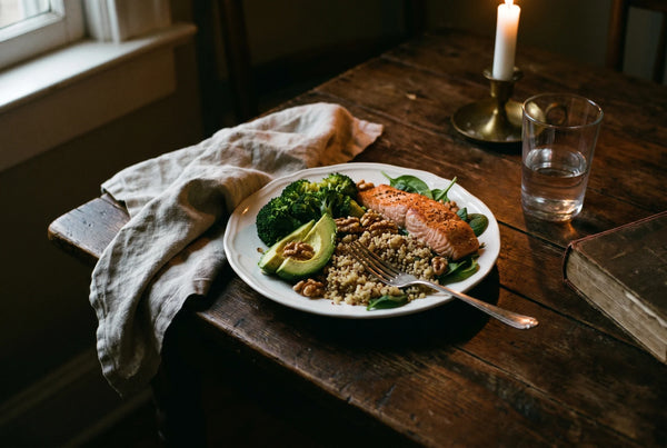 Healthy meal with greens on rustic table with candle representing digestive balance and reduced bloating