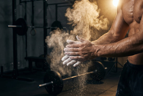 Chalk dust in golden gym light — muscle function support with PURETREX Magnesium Glycinate Complex