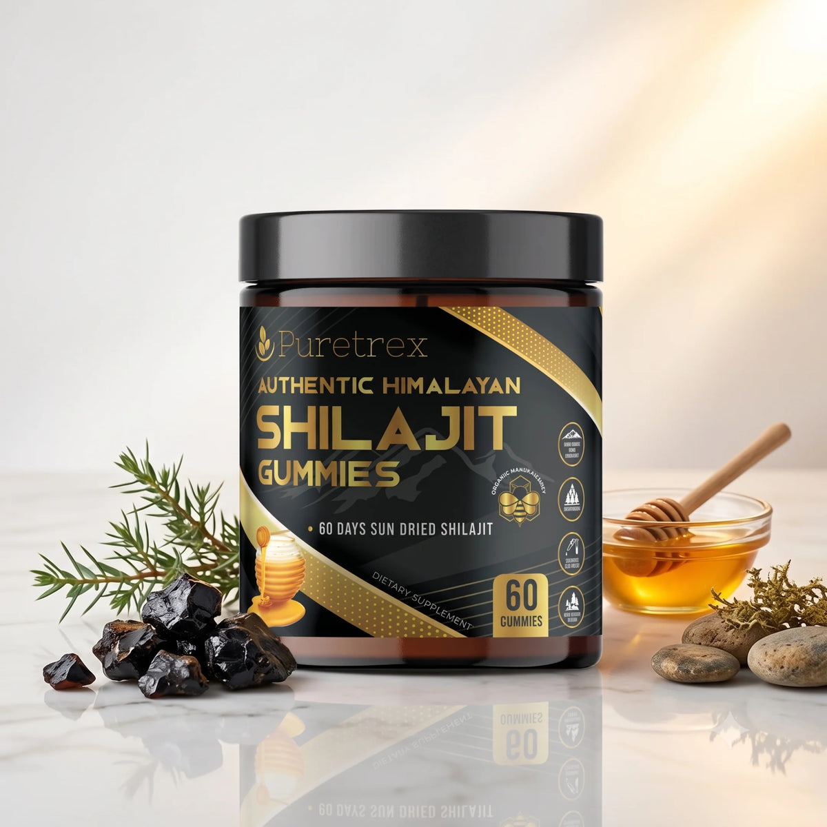 A jar of Puretrex Authentic Himalayan Shilajit Gummies is displayed on a reflective white surface with natural props including raw black shilajit rocks, a sprig of pine, and a glass bowl of golden honey with a wooden dipper. The background is a clean white with a warm, soft light gradient.